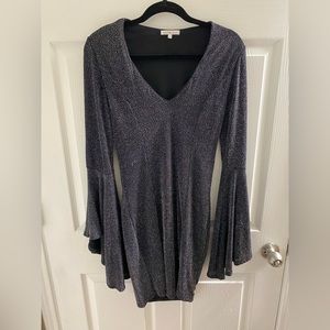 Silver and black shiny short dress with bell sleeves.